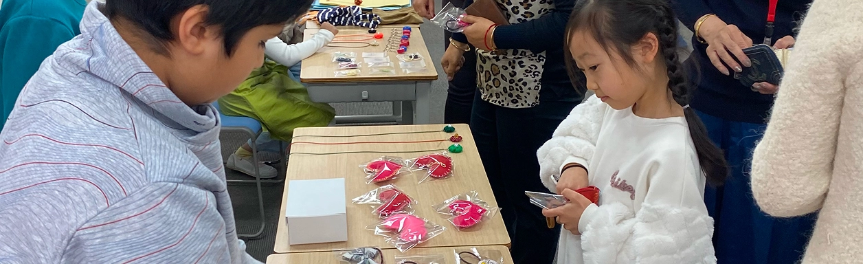 Children participating in a classroom activity with crafts on display, highlighting engagement and creativity.
